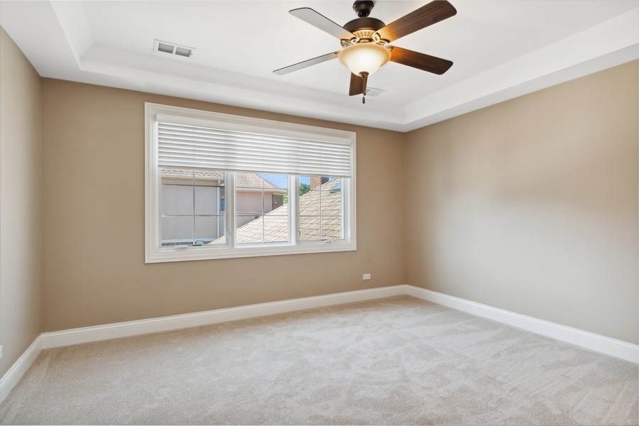 4050 Douglas Road Downers Grove, IL 60515 - Photo 35 of 60 an empty room with a window and a ceiling fan