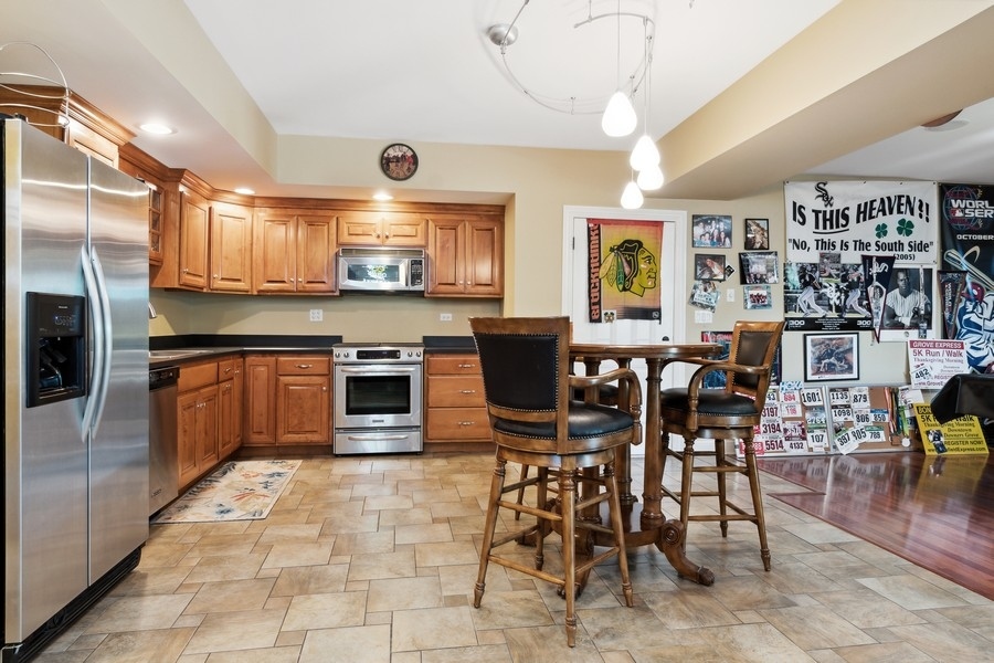4050 Douglas Road Downers Grove, IL 60515 - Photo 38 of 60 a large kitchen with a table and chairs