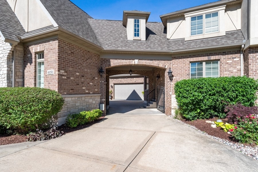 4050 Douglas Road Downers Grove, IL 60515 - Photo 4 of 60 a front view of a house with a garden