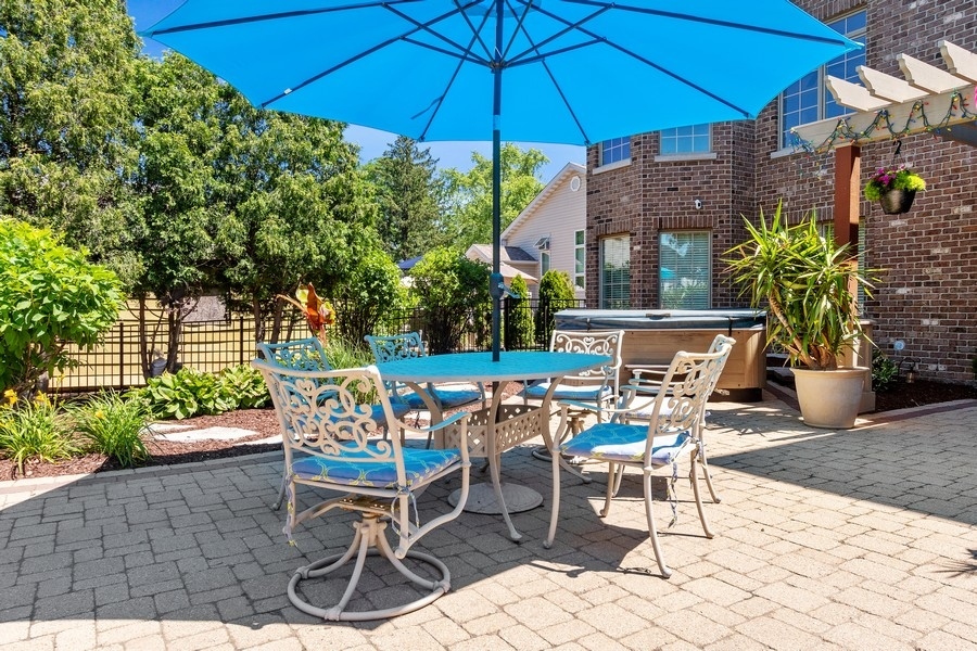 4050 Douglas Road Downers Grove, IL 60515 - Photo 46 of 60 a patio with a patio table and chairs