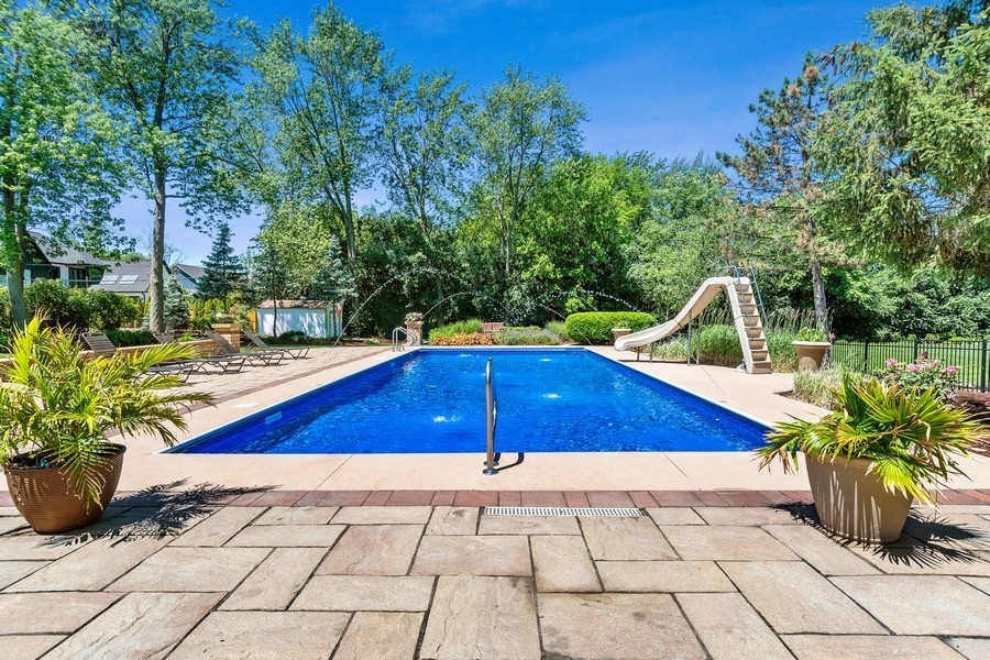 4050 Douglas Road Downers Grove, IL 60515 - Photo 54 of 60 a blue and white umbrella sitting in the backyard of a house