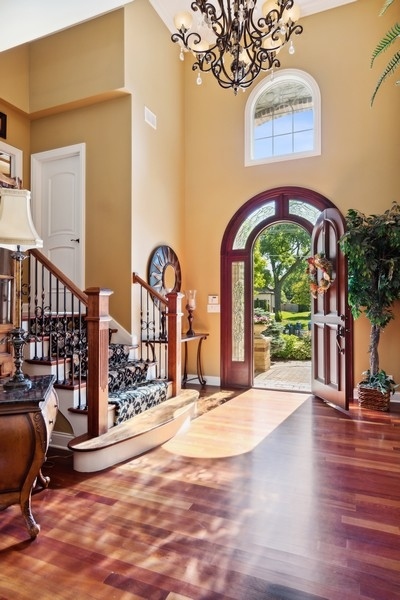 4050 Douglas Road Downers Grove, IL 60515 - Photo 6 of 60 a view of an entryway with a floor to ceiling window and wooden floor