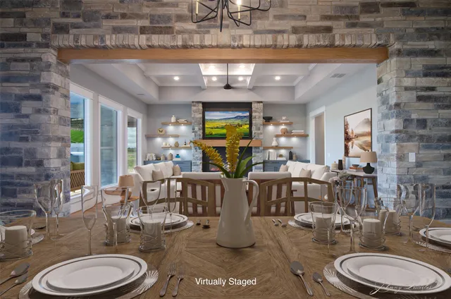 a living room with lots of furniture and view of kitchen