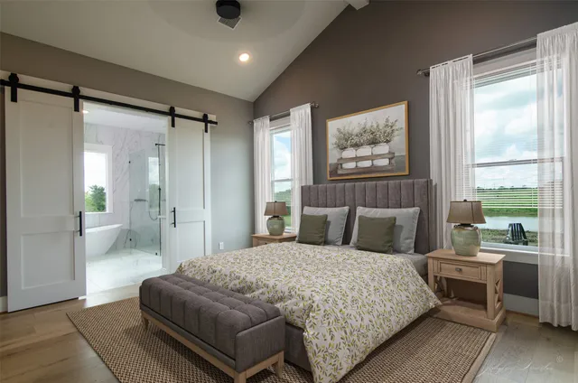 a bedroom with a large bed and a window