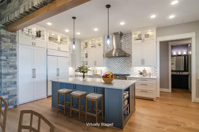 a kitchen with kitchen island granite countertop a sink a center island stainless steel appliances and cabinets