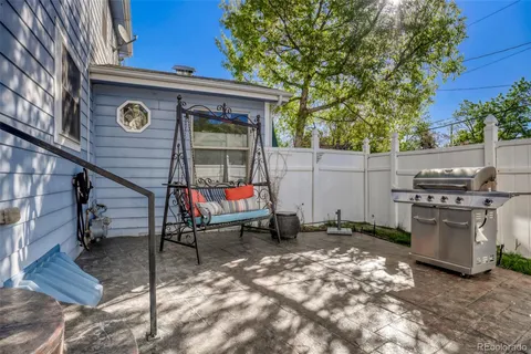 a view of backyard with a table and chairs