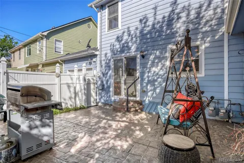 a view of a patio with iron fence