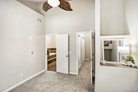 a bathroom with a granite countertop sink a mirror and shower