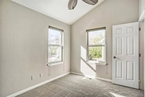a view of hallway with windows and chandelier