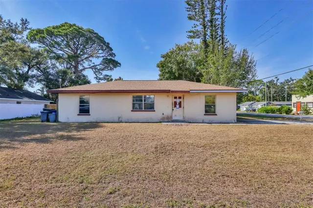 a front view of house with yard and trees