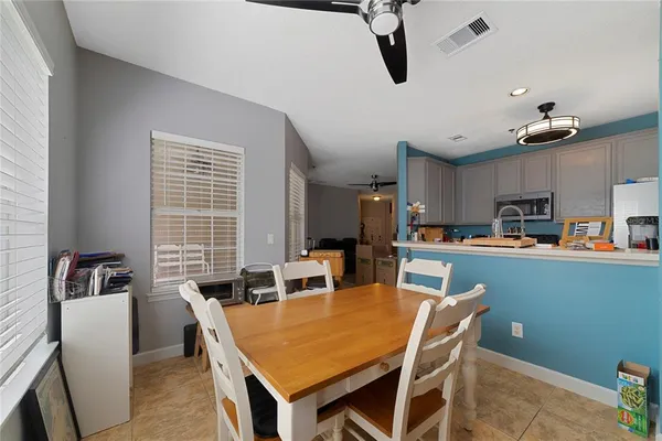 a dining room with kitchen island a table and chairs