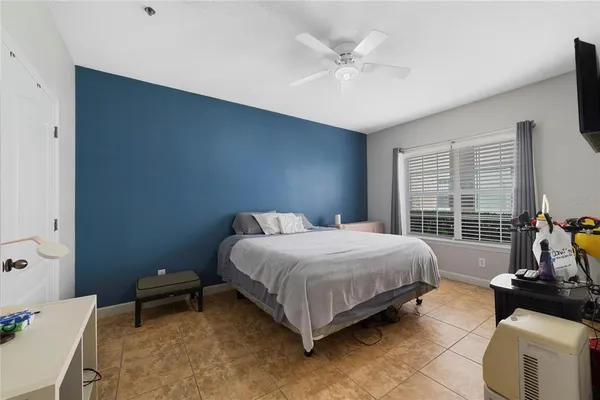 a bedroom with a bed a couch and a window