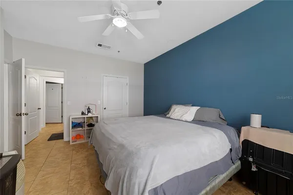 a bedroom with a bed and a chandelier