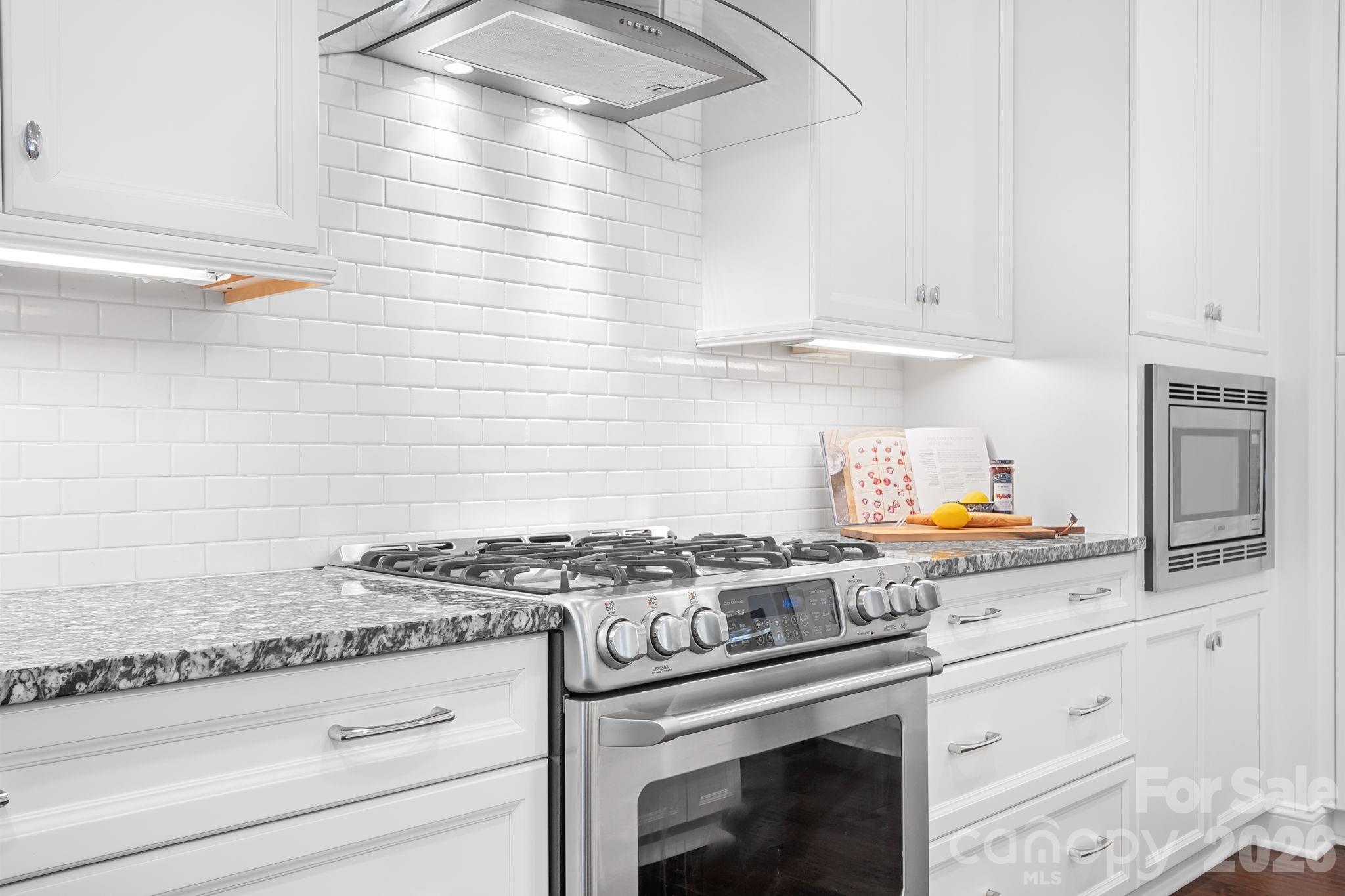 9121 Robbins Preserve Road Cornelius, NC 28031 - Photo 11 of 47 a kitchen with granite countertop cabinets stainless steel appliances and a sink