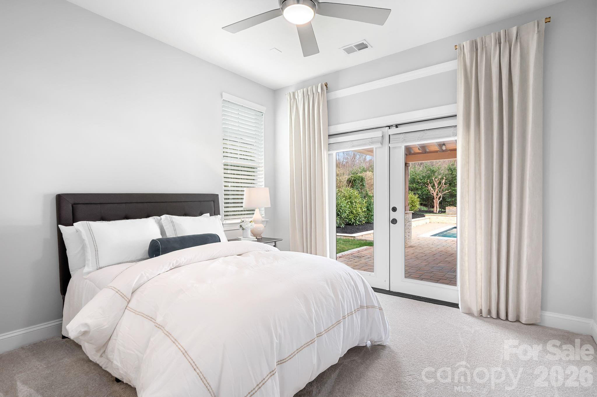 9121 Robbins Preserve Road Cornelius, NC 28031 - Photo 15 of 47 a large bed sitting in a bedroom next to a window