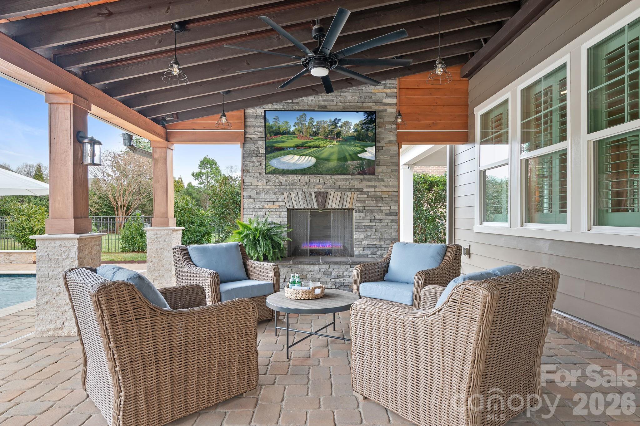 9121 Robbins Preserve Road Cornelius, NC 28031 - Photo 18 of 47 a living room with furniture a fireplace and a floor to ceiling window