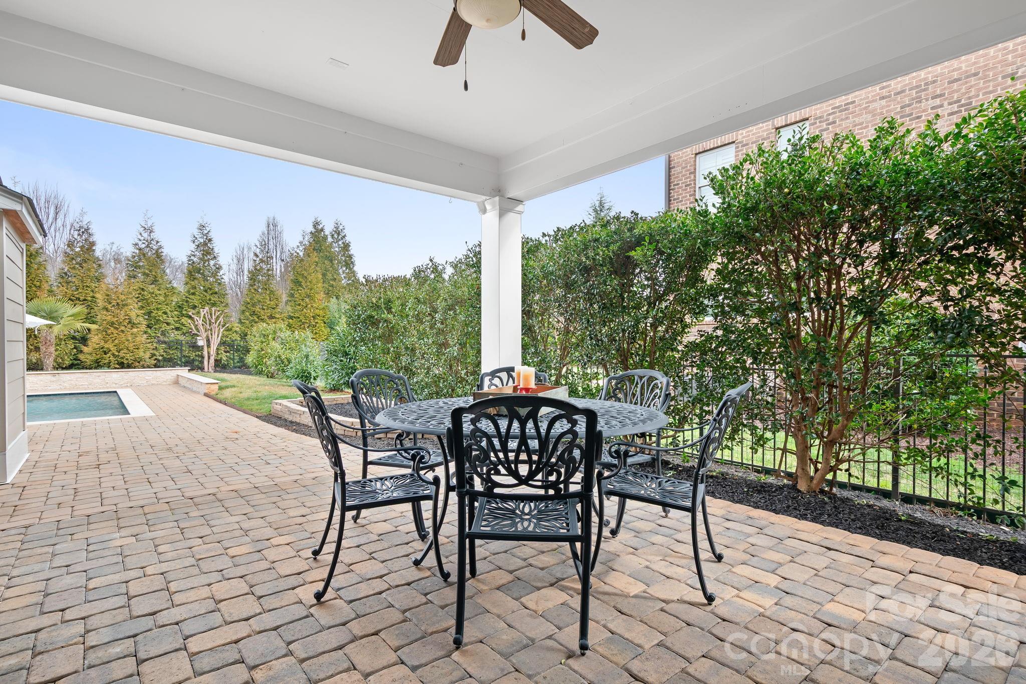 9121 Robbins Preserve Road Cornelius, NC 28031 - Photo 20 of 47 a patio with a yard table and chairs