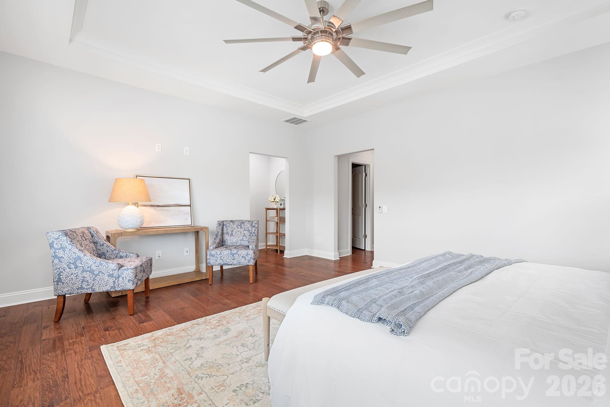 9121 Robbins Preserve Road Cornelius, NC 28031 - Photo 25 of 47 a spacious bedroom with a bed a table and chair