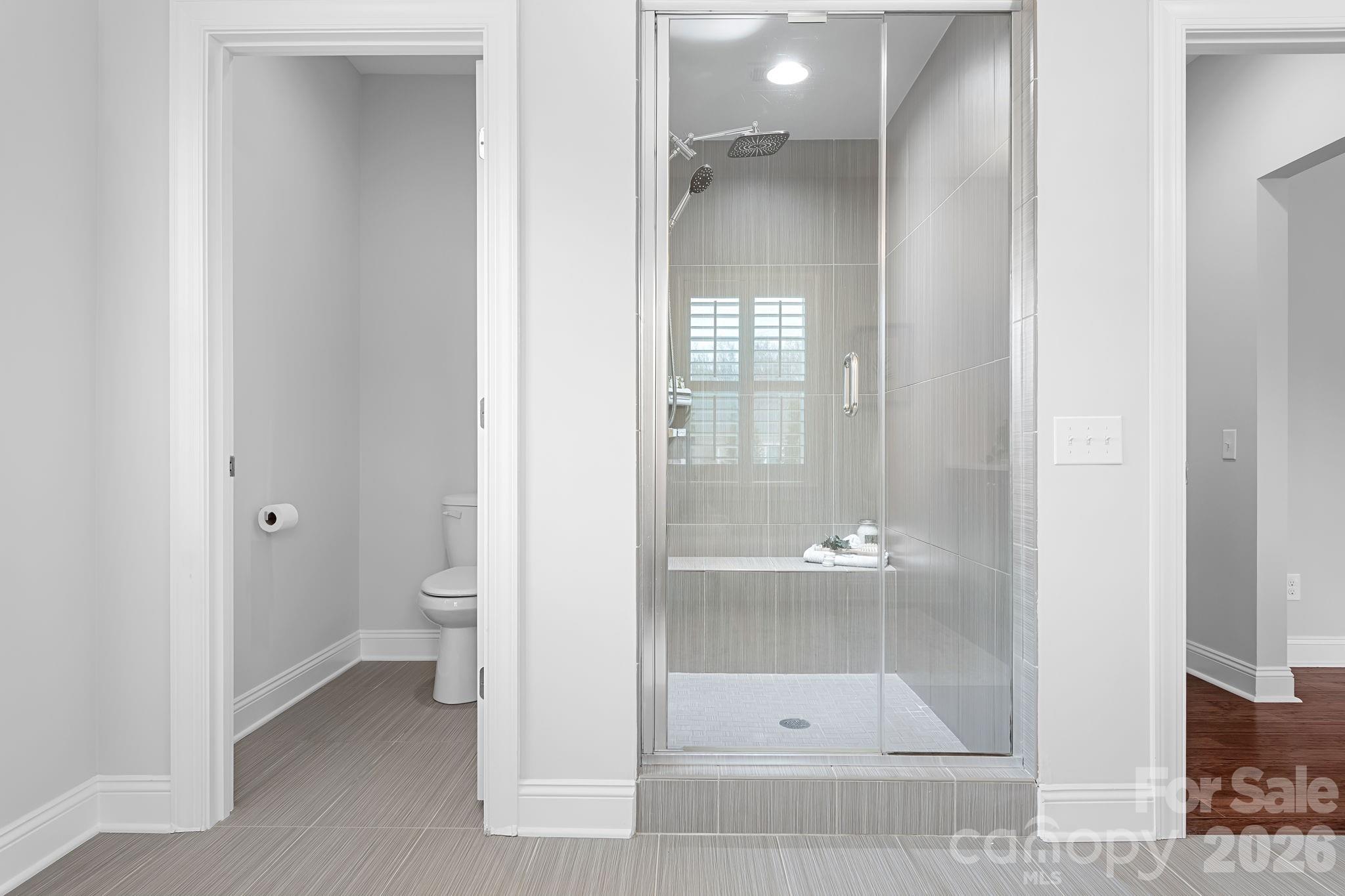 9121 Robbins Preserve Road Cornelius, NC 28031 - Photo 27 of 47 a bathroom with a glass door and a glass door
