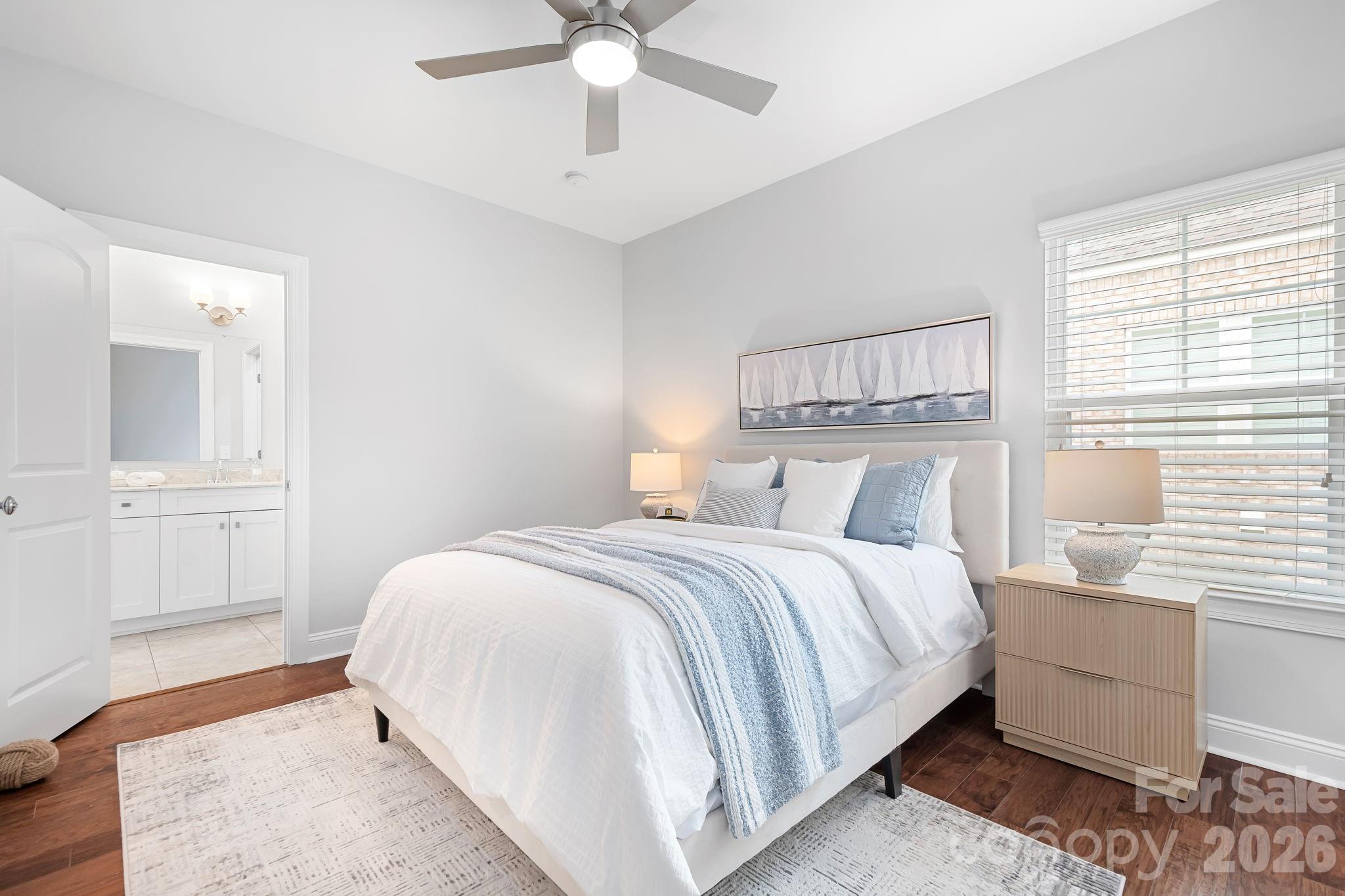 9121 Robbins Preserve Road Cornelius, NC 28031 - Photo 29 of 47 a bedroom with a large bed and a chandelier