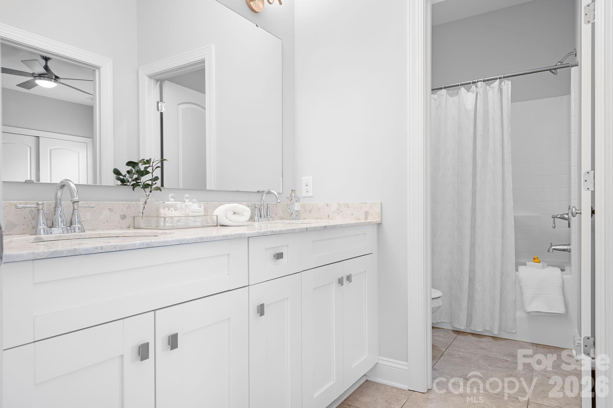 9121 Robbins Preserve Road Cornelius, NC 28031 - Photo 30 of 47 a bathroom with a double vanity sink and a mirror