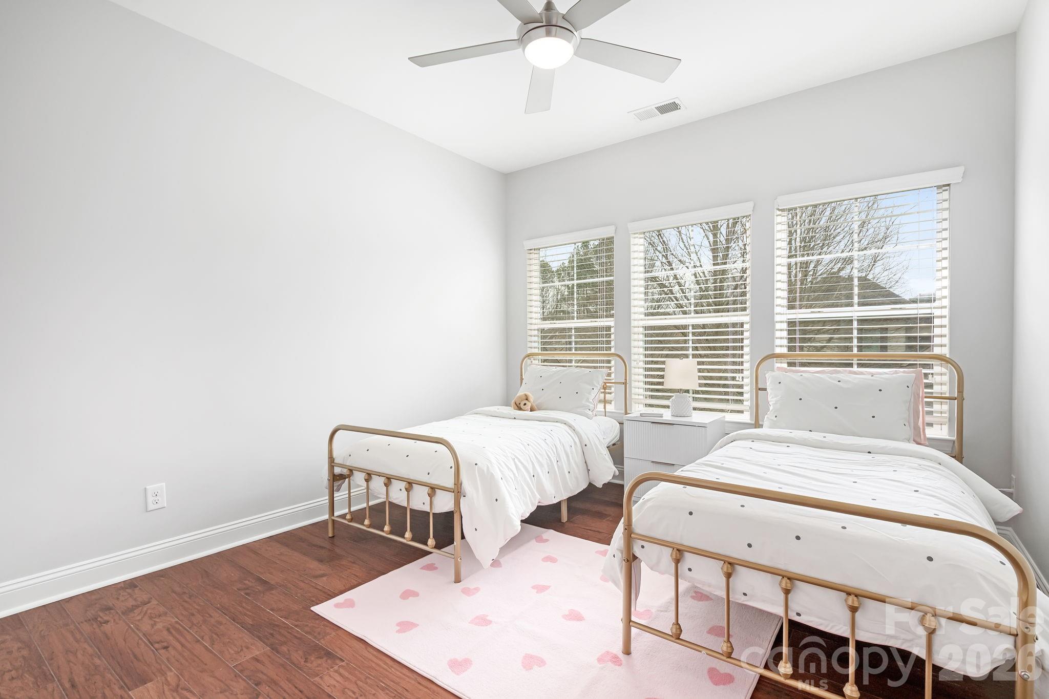 9121 Robbins Preserve Road Cornelius, NC 28031 - Photo 31 of 47 a spacious bedroom with a bed and wooden floor