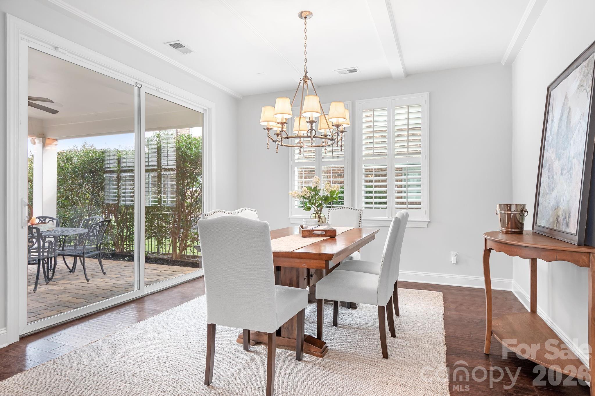 9121 Robbins Preserve Road Cornelius, NC 28031 - Photo 7 of 47 a dining room with furniture a chandelier and wooden floor