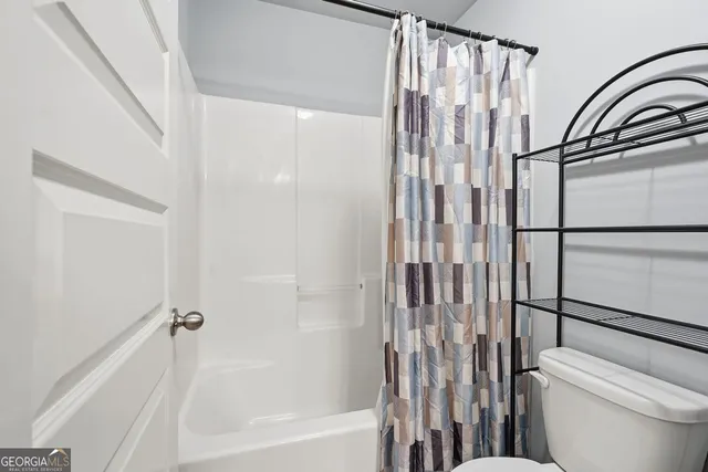 a bathroom with a shower curtain