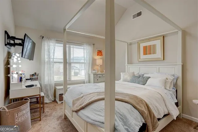 a bedroom with a bed and a couch