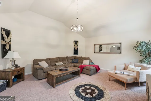 a living room with furniture a rug and a window