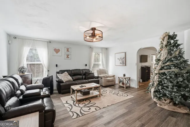 a living room with furniture and wooden floor