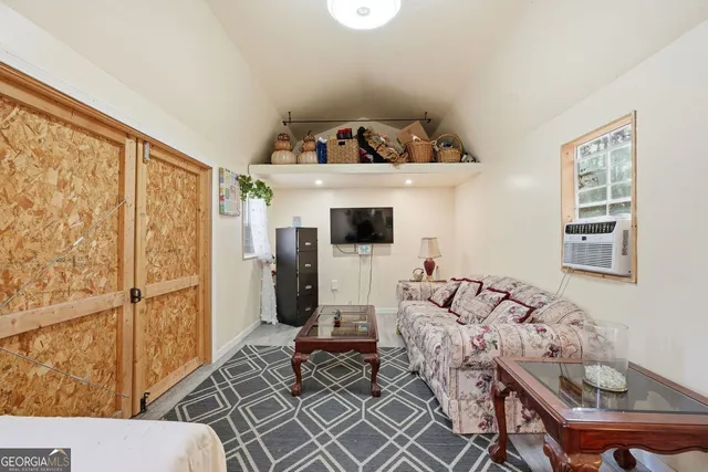 a living room with furniture and a painting on the wall