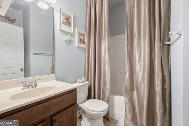 a bathroom with a sink toilet and a mirror