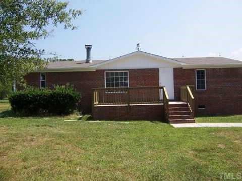 3204 Broughton Road Wendell, NC 27591 - Photo 1 of 1 a front view of a house with garden