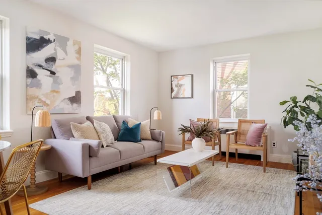 a living room with furniture and a potted plant