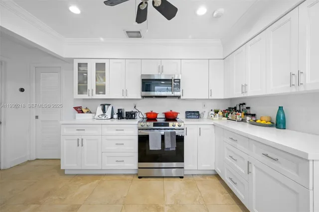a kitchen with stainless steel appliances granite countertop a stove and cabinets