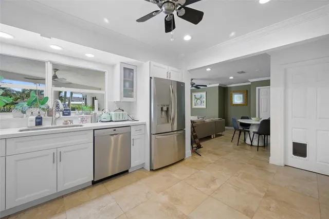 a kitchen with refrigerator and cabinets