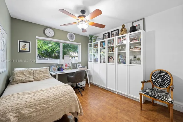 a bedroom with a bed and a large window