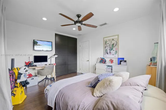 a bedroom that has a bed and a chandelier
