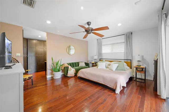 a spacious bedroom with a bed and a chandelier