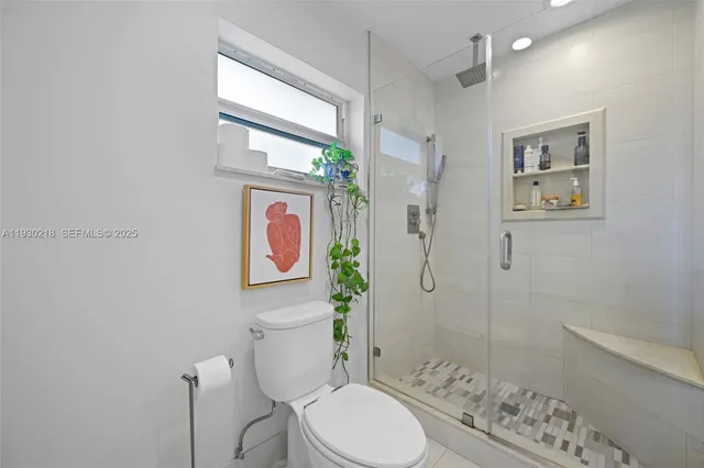 a bathroom with a toilet sink and shower