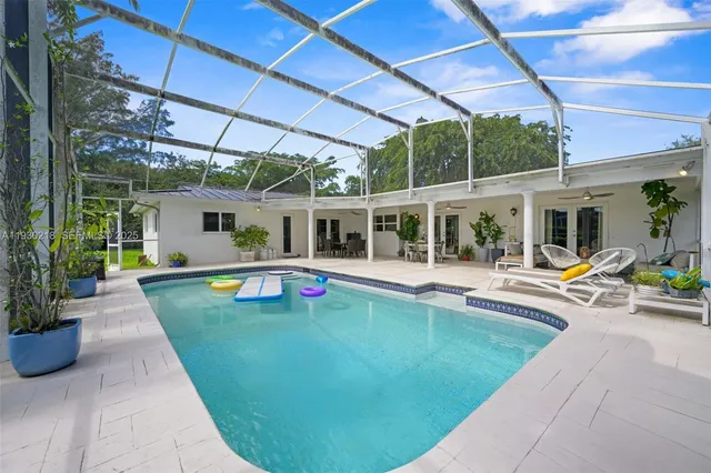 a view of a patio with swimming pool table and chairs