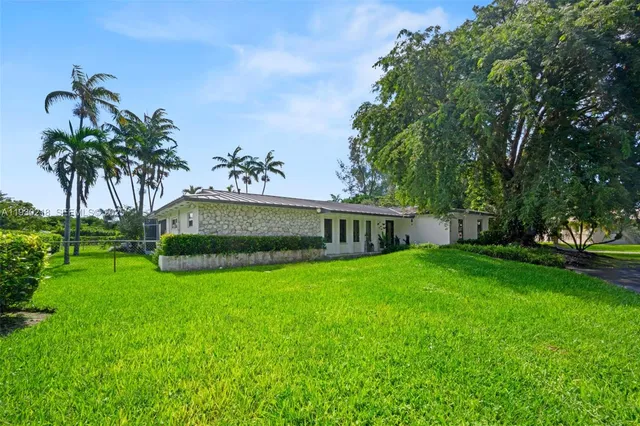a view of a garden with a house
