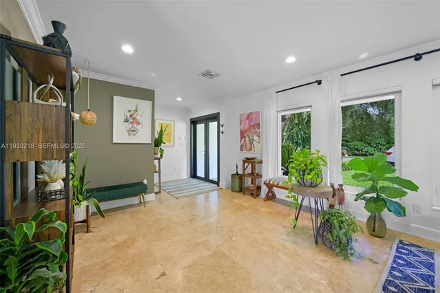a living room with furniture and a potted plant