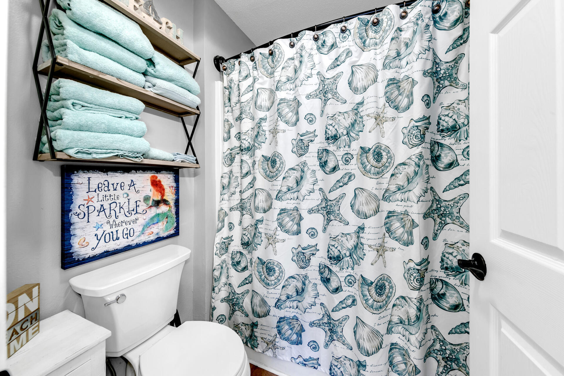 200 Sandestin Lane, Unit 602 Miramar Beach, FL 32550 - Photo 13 of 17 a white toilet sitting next to a shower curtain