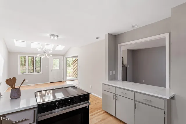a kitchen with sink stove and cabinets