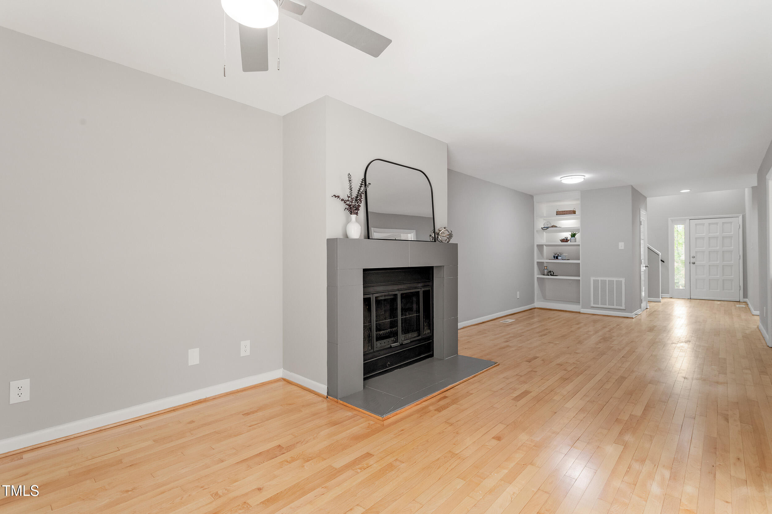 58 Stoneridge Road Durham, NC 27705 - Photo 14 of 38 a view of an empty room with wooden floor fireplace and a window