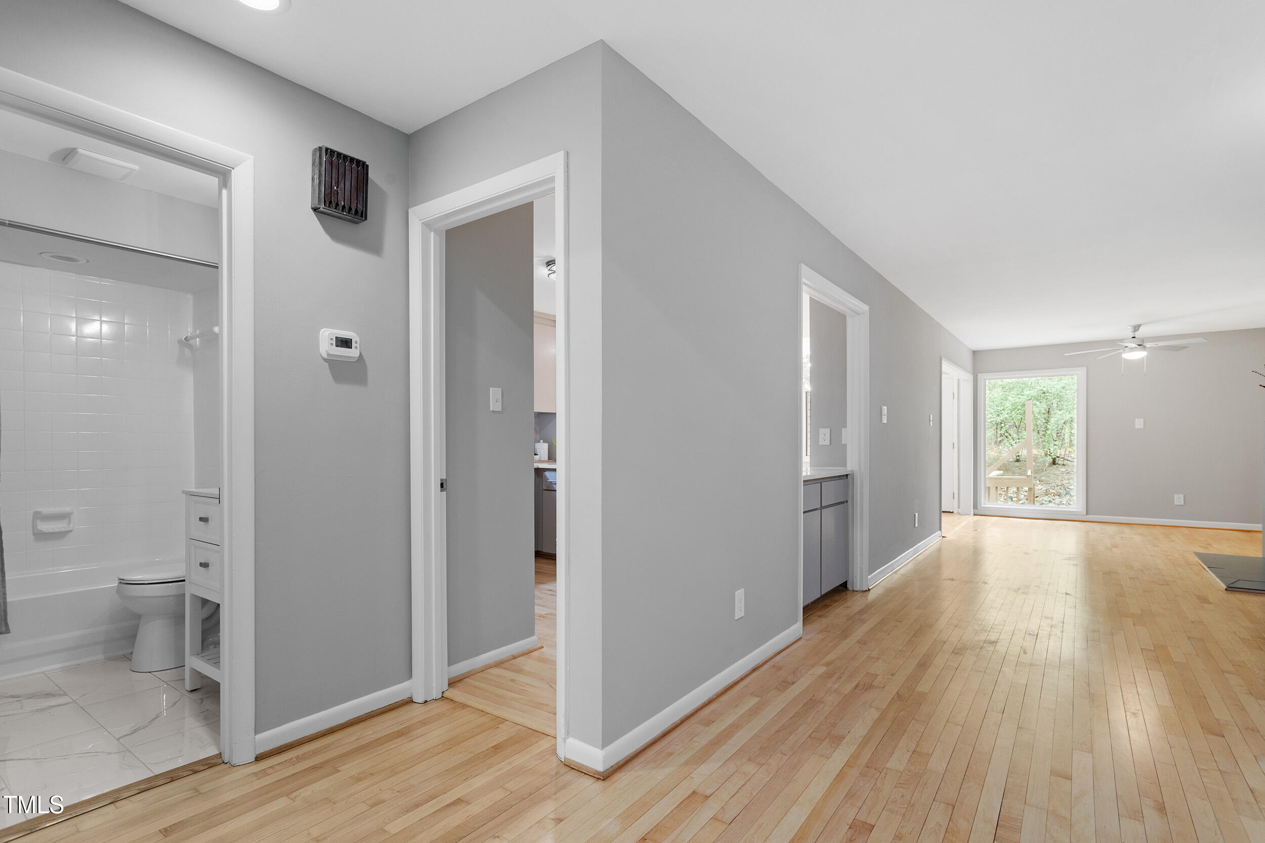 58 Stoneridge Road Durham, NC 27705 - Photo 18 of 38 a view of an empty room with wooden floor and a bathroom