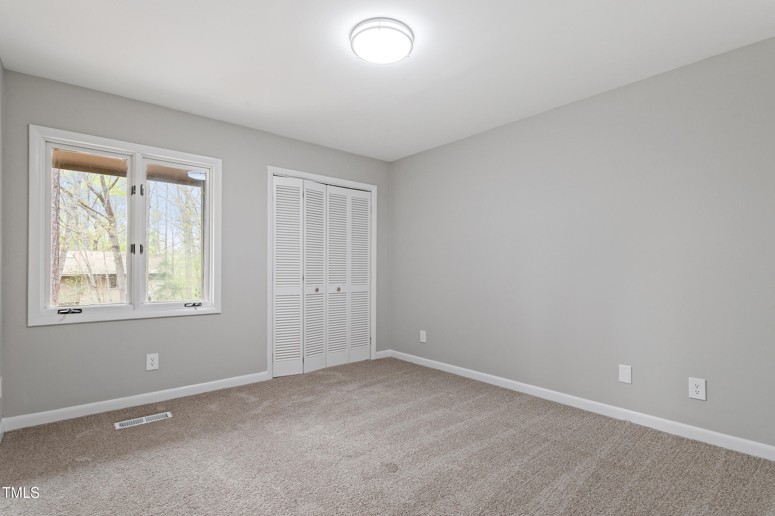 58 Stoneridge Road Durham, NC 27705 - Photo 21 of 38 an empty room with windows