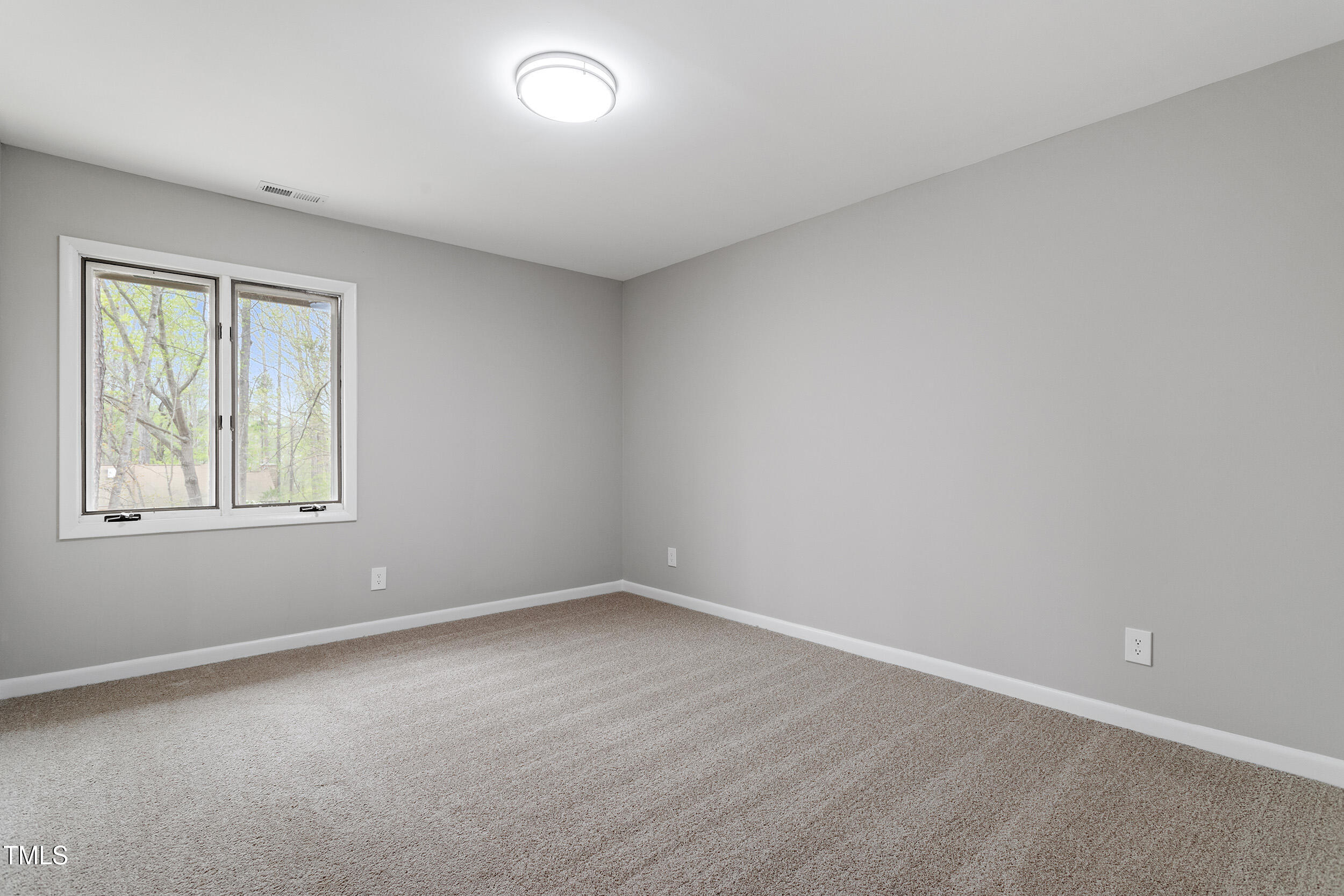 58 Stoneridge Road Durham, NC 27705 - Photo 24 of 38 an empty room with a window